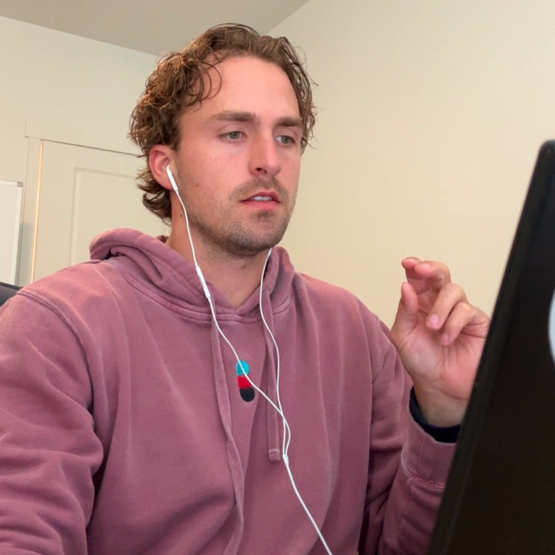 Drew working on the TIDLØS website and business at his laptop